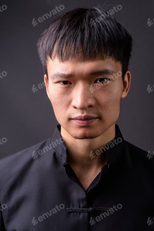 Preview: Studio shot of young Chinese man against gray background