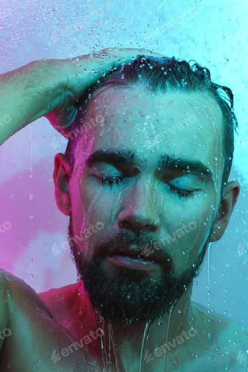 Preview: Handsome man under water flow in neon light