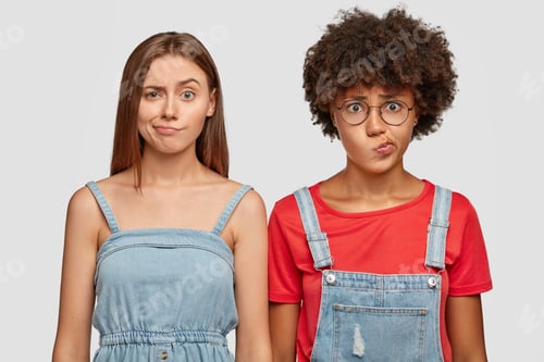 Preview: Indignant displeased women purse lips with dissatisfaction, has gloomy facial expression, feel puzzl
