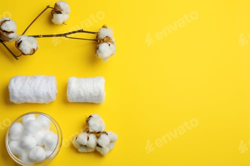 Preview: Flat lay composition with cotton rolls and balls on color background, space for text