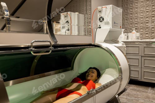 Preview: Woman lying in oxygen capsule