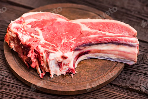 Preview: Raw beef steak on wooden cutting board