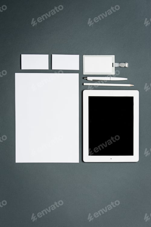 Preview: Mock-up business template with cards, papers, tablet. Gray background.