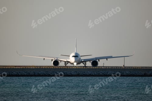 Preview: White commercial airplane on a taxiway at the Naha International Airport in Okinawa, Japan.