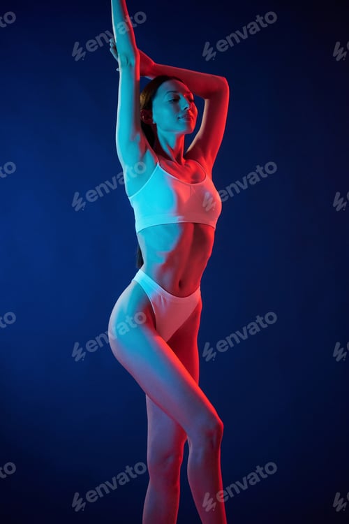 Preview: Young woman in underwear is in the studio with neon lights