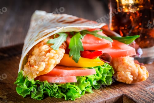 Preview: Closeup of tasty tortilla with vegetables and chicken