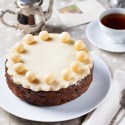 Preview: Traditional English Easter cake with marzipan decoration on a white plate.