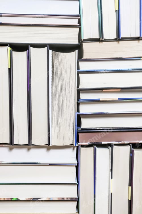 Preview: stack of books, close up. Open book on the table in library.