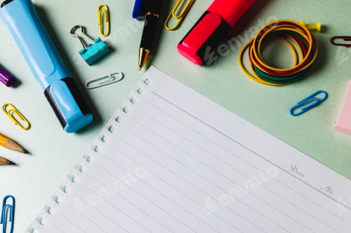Preview: Composition of notebook with copy space and school tools on green surface