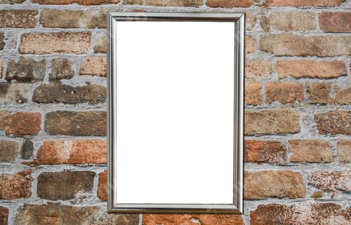 Preview: Soft focus of an empty frame against a brick wall