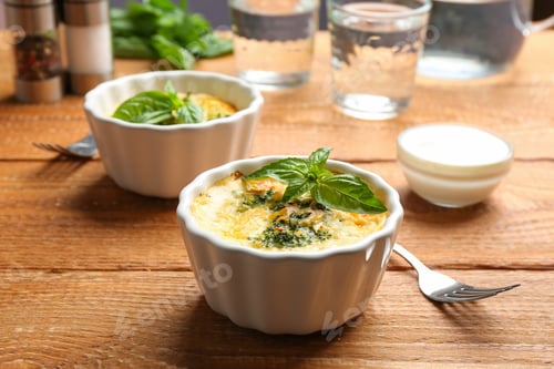 Preview: Tasty broccoli casserole in ramekins on wooden table