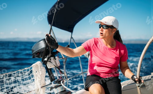 Preview: Happy strong woman sailing with her boat