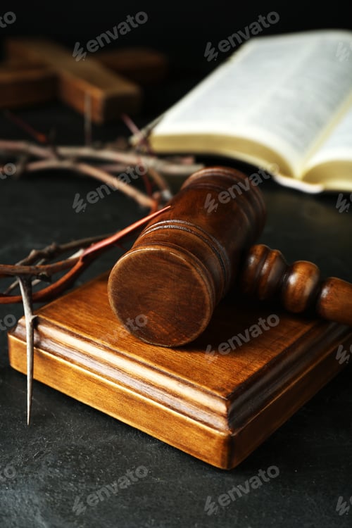 Preview: Wooden judge gavel and crown of thorns on black table, closeup