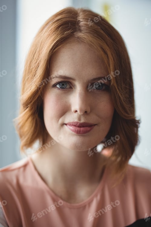Smiling Woman Posing in Front of Window