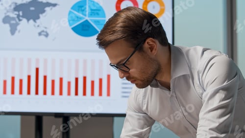 Preview: Young man in a white shirt preparing for a presentation