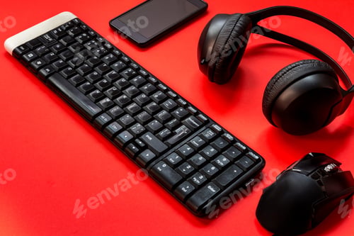 Preview: Game keyboard, headphones, mouse accessories for a gamer on a red background. flat lay top view with