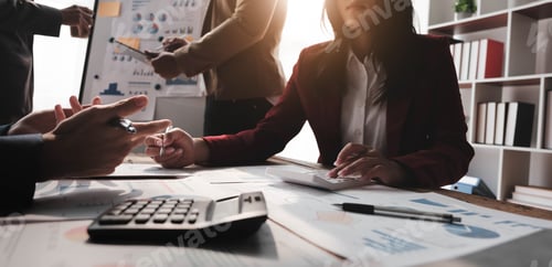 Preview: Business People Meeting using laptop computer,calculator,notebook,stock market chart paper for