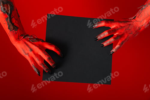 Preview: Spooky, red hands of the monster hold a black sheet