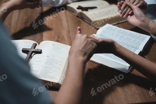 Preview: Asian men and women hands praying to god with the bible. P