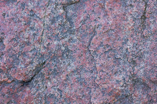 Preview: Texture Of Granite Close Up. Granite Rock With Reddish Color. Background From Solid Stone. Pattern