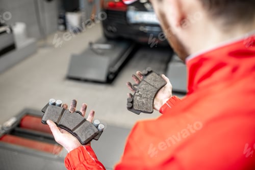 Preview: Holding brake pads at the car service