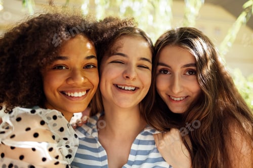 Preview: Closeup portrait of three pretty female teenagers of different nationalities in casual clothes