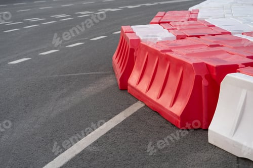 Preview: Temporary road barriers installed on asphalt with intermittent markings to prevent accidents