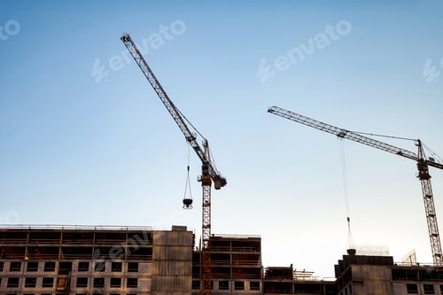 Preview: Construction Cranes Working at an Urban Site in Bright Daylight
