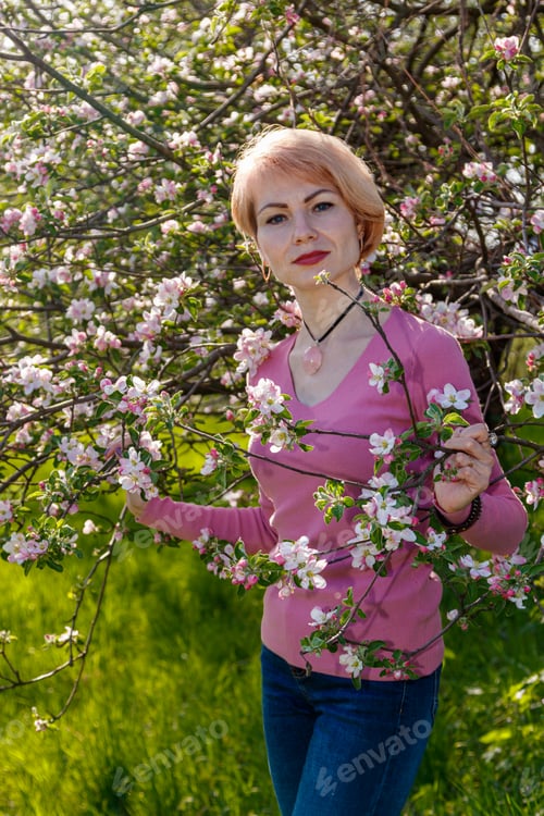 Preview: Beautiful girl in the arms of a child girl in a blooming park