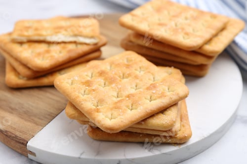 Preview: Tasty salty crackers on white table, closeup