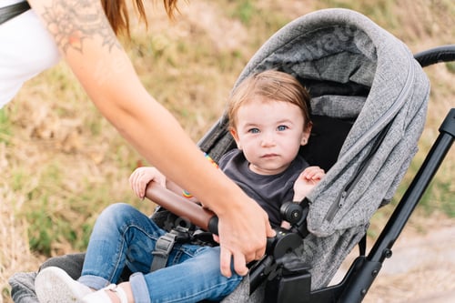 Preview: Mother securing a baby carriage on a country road