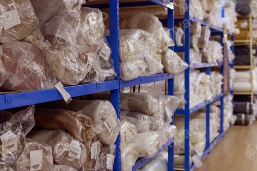 Preview: Interior of a industrial warehouse with fabric rolls.