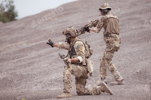 Preview: Soldiers in camouflage military uniforms carrying weapons Reconnaissance missions in rugged mountain