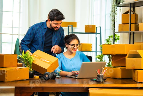 Preview: Small Indian business partners handling garment packaging and laptop inventory entry