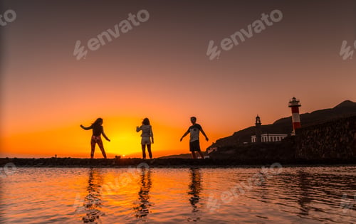 Preview: Three friends in the orange sunset on the salt flats and in the background