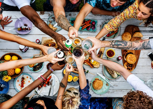 Preview: Aerial view of diverse hands clinking beverage together