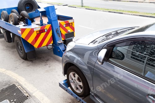 Preview: Tow truck towing a broken down car on the street