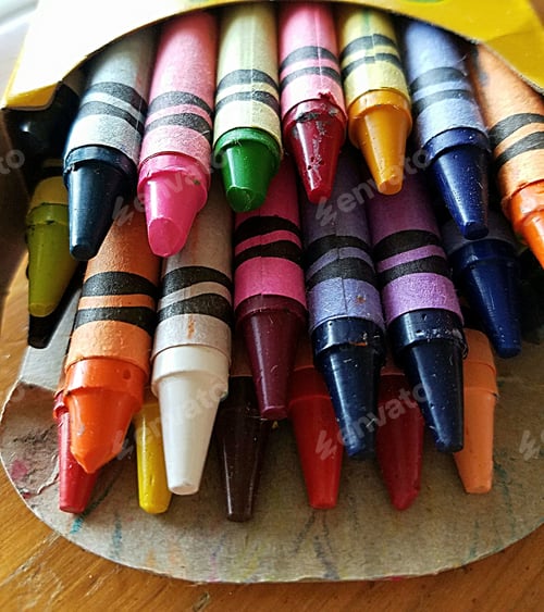 Preview: Closeup of an open box of new colorful crayons.