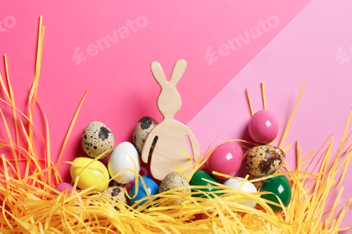 Preview: Flat lay composition of Easter bunny figure and eggs on color background