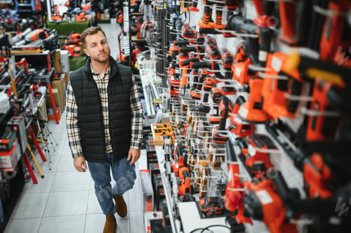Preview: A man chooses a power tool in a hardware store