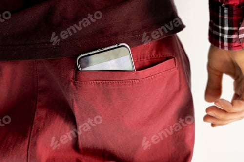 Preview: a close up smartphone inside the pocket of male clothes, back view, as symbol of health effect from