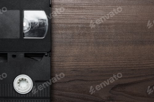 Preview: Old Retro Video Tapes Over Wooden Background