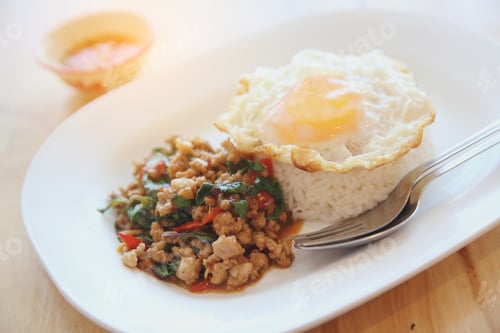 Preview: Stir Fried Pork And Basil With Rice And Egg On Wood Background Thai Food