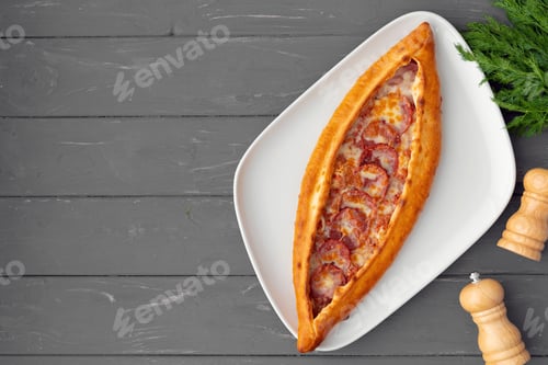 Preview: Turkish stuffed flatbread pide on gray wooden table