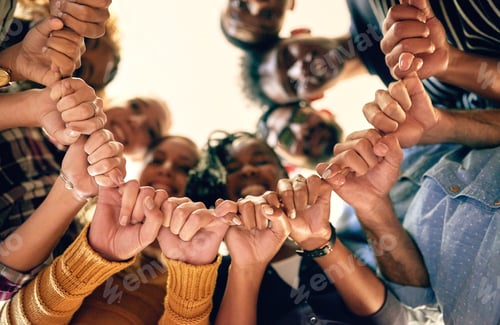 Preview: Low angle shot of a group of people joining their hands together