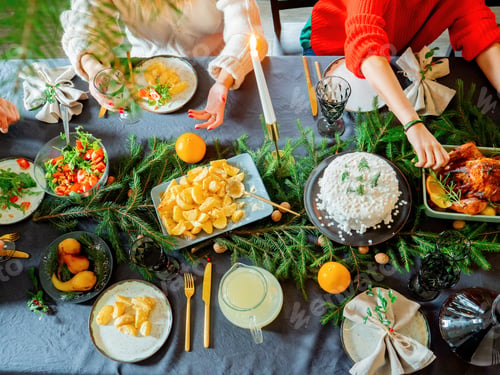Preview: family sits at christmas table full of food