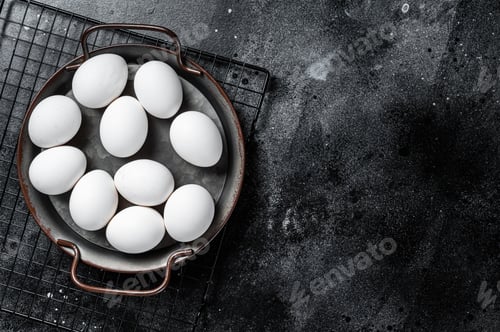 Preview: Plate with organic farm white chicken eggs. Black background. Top view. Copy space