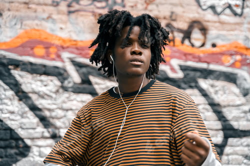 Preview: Portrait of young handsome dancing stylish black man with natural hair afro dreadlocks. Afroamerican