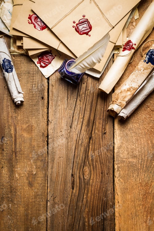 Preview: Old rolls of paper and blue ink in the inkwell as vintage background