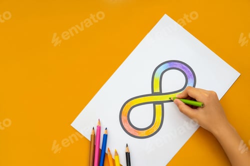 Preview: A hand coloring a rainbow infinity symbol on a white sheet of paper.